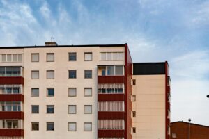 Multifamily apartment building exterior in the Indianapolis metro — bed bug pressure compounds in apartments because shared walls, plumbing chases, and electrical runs let infestations migrate between units before tenants ever report a sighting