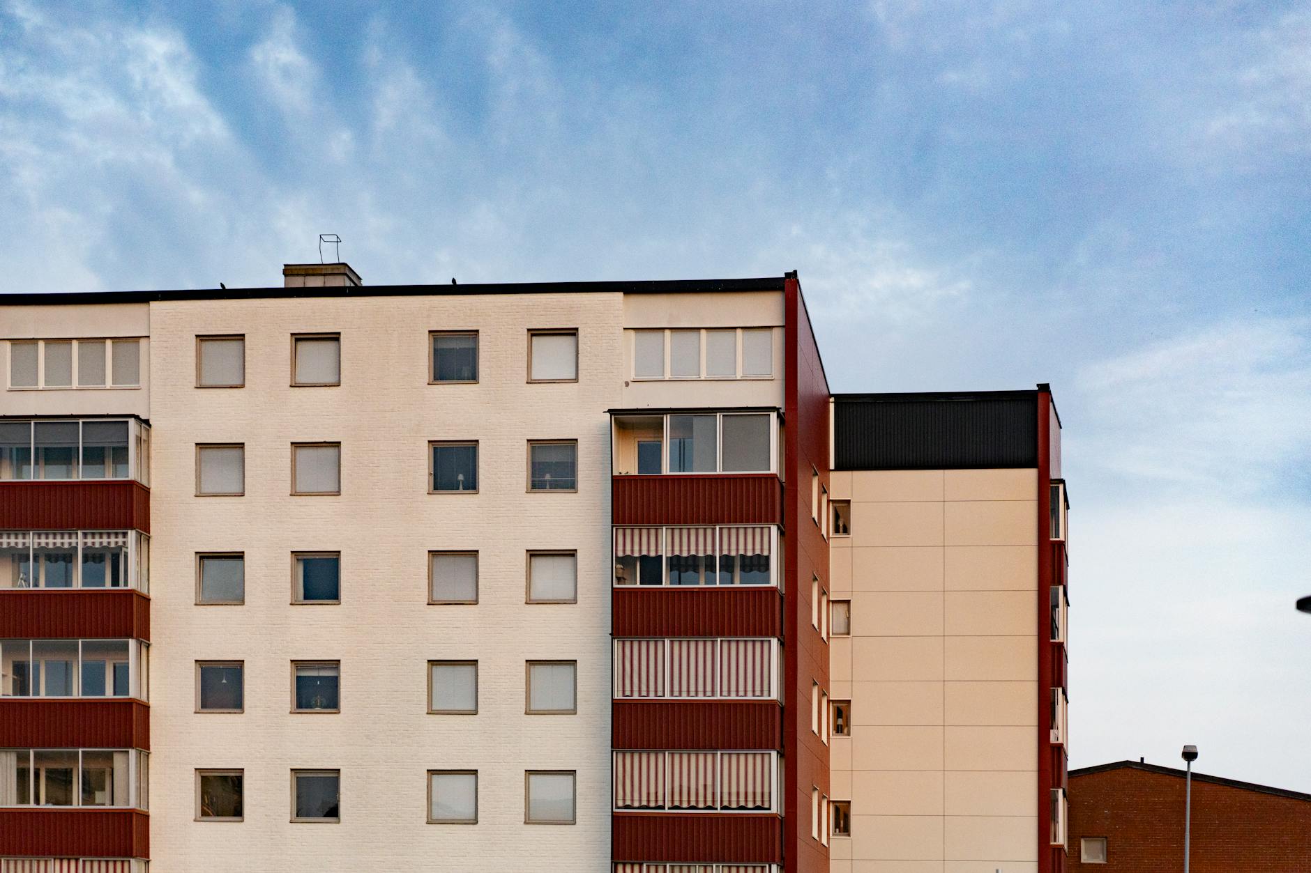 Multifamily apartment building exterior in the Indianapolis metro — bed bug pressure compounds in apartments because shared walls, plumbing chases, and electrical runs let infestations migrate between units before tenants ever report a sighting
