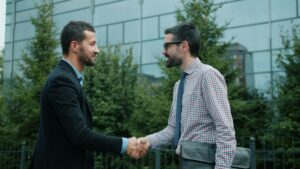 Indianapolis facility manager and a new commercial pest control provider closing a vendor transition meeting — switching providers without service gaps requires deliberate handoff documentation and overlap planning