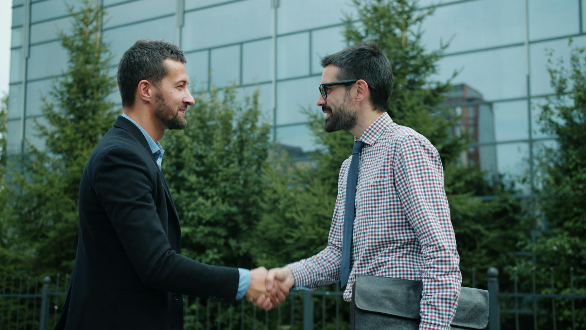 Indianapolis facility manager and a new commercial pest control provider closing a vendor transition meeting — switching providers without service gaps requires deliberate handoff documentation and overlap planning